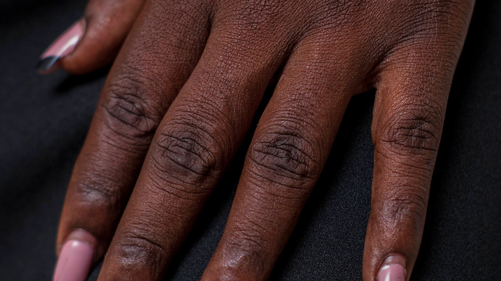 A hand painted nail art detail in muted tones